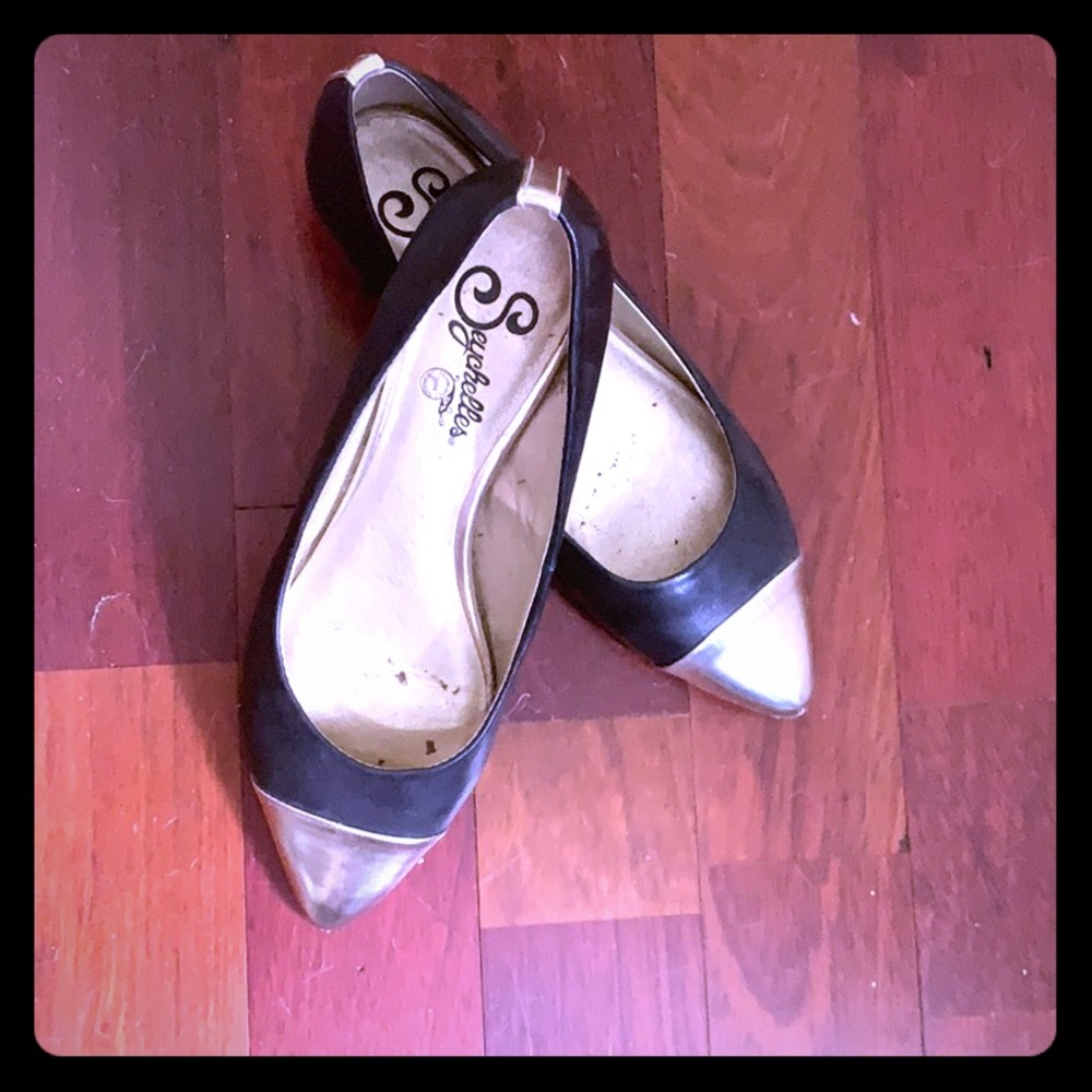 Black flats with silver cap toes and trim
